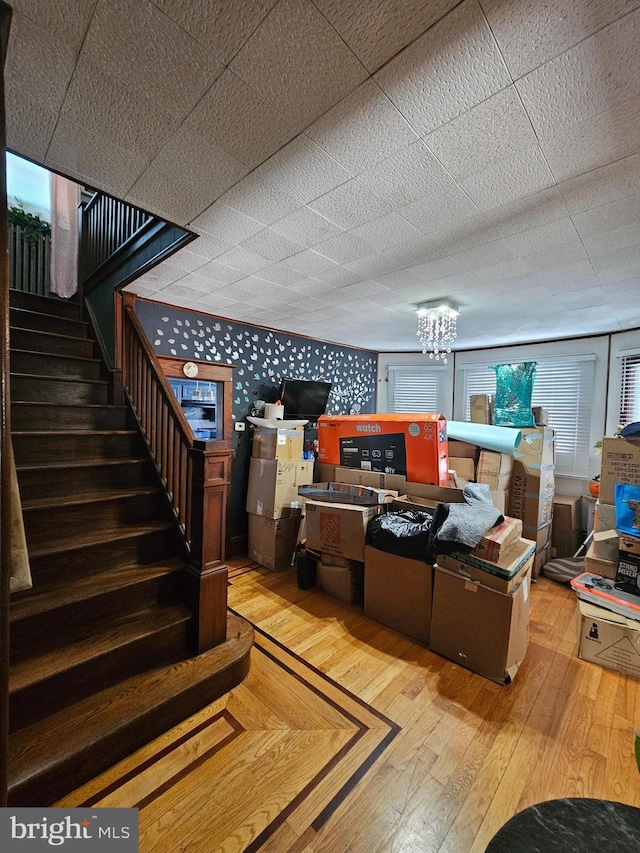 1666 Browning Rd, Pennsauken, NJ 08110 - basement with light wood-type flooring, stairway, a chandelier, and wallpapered walls