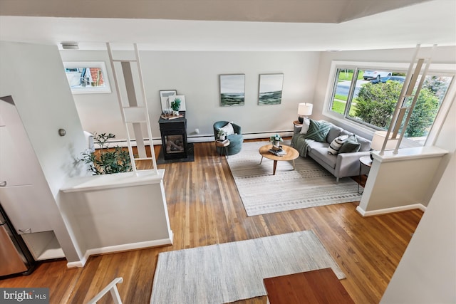 10400 Conover Dr, Silver Spring, MD 20902 - living room featuring a baseboard heating unit, wood finished floors, and baseboards