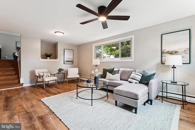 10400 Conover Dr, Silver Spring, MD 20902 - living room with a baseboard radiator, wood finished floors, stairway, a ceiling fan, and baseboards