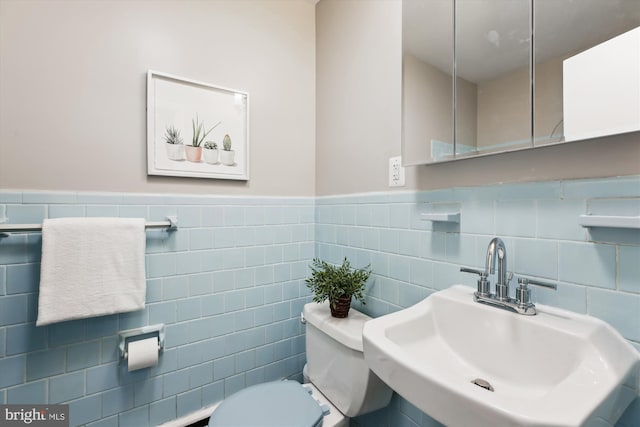 10400 Conover Dr, Silver Spring, MD 20902 - bathroom featuring a sink, toilet, a wainscoted wall, and tile walls