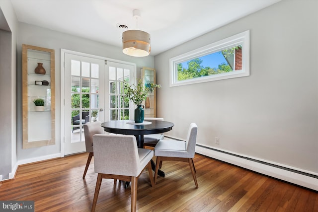 10400 Conover Dr, Silver Spring, MD 20902 - dining room featuring baseboard heating, baseboards, and wood finished floors