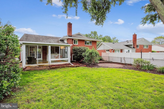 10400 Conover Dr, Silver Spring, MD 20902 - rear view of house featuring a sunroom, brick siding, and a chimney
