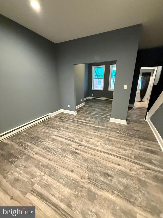 2324 N Lambert St, Philadelphia, PA 19132 - unfurnished room featuring wood finished floors, baseboards, and a baseboard radiator