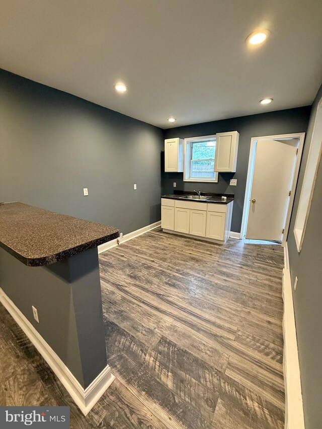 2324 N Lambert St, Philadelphia, PA 19132 - kitchen featuring dark countertops, recessed lighting, baseboards, white cabinetry, and dark wood-type flooring