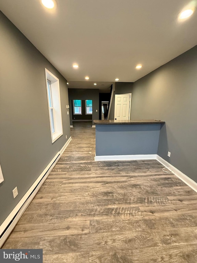 2324 N Lambert St, Philadelphia, PA 19132 - kitchen with a baseboard heating unit, wood finished floors, recessed lighting, baseboards, and dark countertops