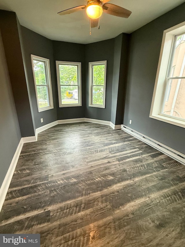 2324 N Lambert St, Philadelphia, PA 19132 - unfurnished room with baseboard heating, plenty of natural light, ceiling fan, and dark wood finished floors