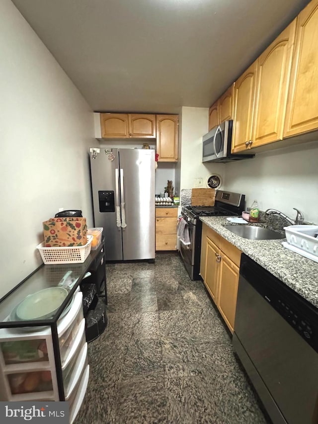 7332 Lee Hwy Unit 201, Falls Church, VA 22046 - kitchen featuring appliances with stainless steel finishes, a sink, light stone counters, and granite floors