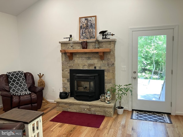 347 Lakewood Cir, Mineral, VA 23117 - living room featuring wood finished floors, lofted ceiling, baseboards, and a wood stove