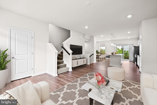 641 S Haven St, Baltimore, MD 21224 - living area with dark wood-style flooring, recessed lighting, stairs, and baseboards