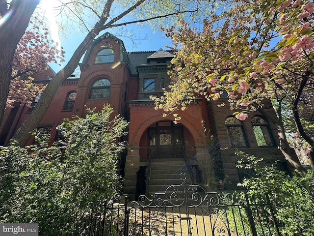 1752 17th St NW, Washington, DC 20009 - view of front facade featuring a fenced front yard, stone siding, brick siding, and a gate