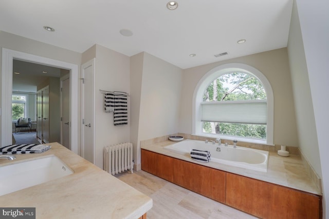 1752 17th St NW, Washington, DC 20009 - full bath featuring radiator heating unit, a garden tub, healthy amount of natural light, vanity, and recessed lighting