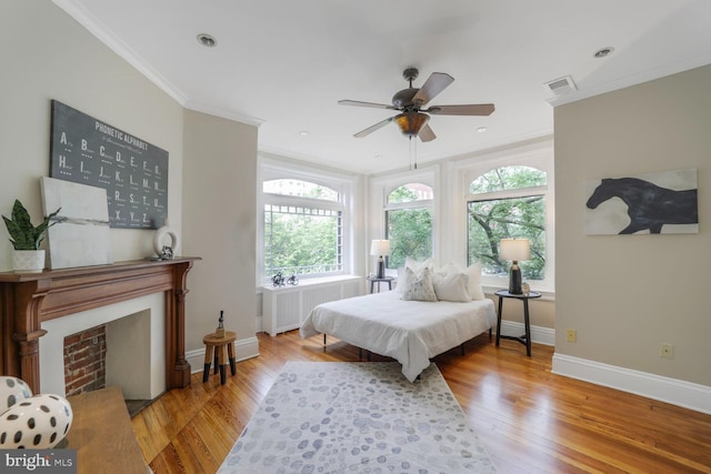 1752 17th St NW, Washington, DC 20009 - bedroom featuring radiator heating unit, crown molding, baseboards, wood finished floors, and a fireplace