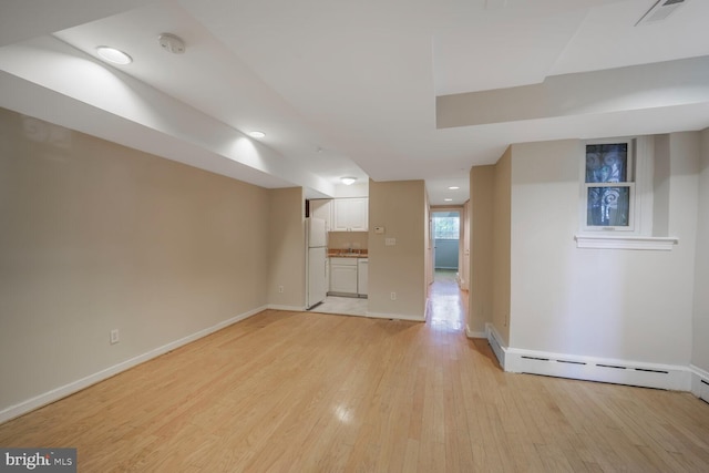 1752 17th St NW, Washington, DC 20009 - unfurnished living room featuring light wood finished floors, baseboards, recessed lighting, and a baseboard radiator