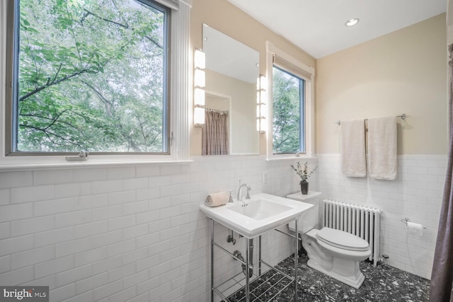 1752 17th St NW, Washington, DC 20009 - bathroom featuring radiator, tile walls, toilet, and a wainscoted wall