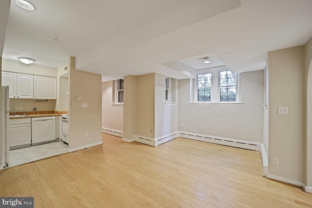 1752 17th St NW, Washington, DC 20009 - unfurnished living room with a sink, light wood-type flooring, a baseboard radiator, and baseboards