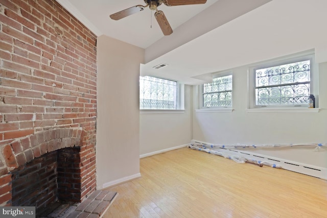 1752 17th St NW, Washington, DC 20009 - unfurnished living room with hardwood / wood-style floors, baseboards, a ceiling fan, and a brick fireplace