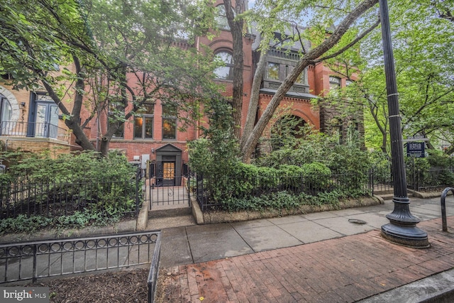 1752 17th St NW, Washington, DC 20009 - view of front of house featuring a gate, brick siding, and a fenced front yard