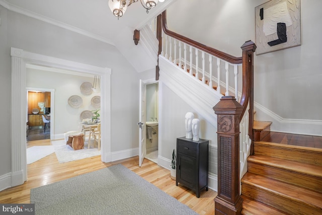 1752 17th St NW, Washington, DC 20009 - stairs with wood finished floors, crown molding, baseboards, and a chandelier