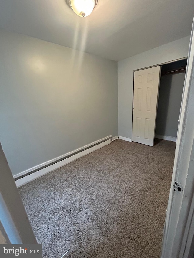 2229 Memphis St, Philadelphia, PA 19125 - unfurnished bedroom with a baseboard heating unit, a closet, baseboards, and dark carpet
