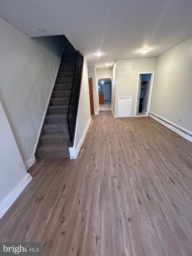 2229 Memphis St, Philadelphia, PA 19125 - unfurnished living room featuring wood finished floors, baseboards, stairs, and arched walkways