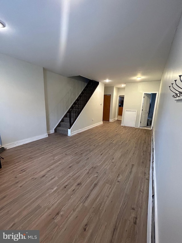 2229 Memphis St, Philadelphia, PA 19125 - unfurnished living room featuring wood finished floors, stairway, and baseboards