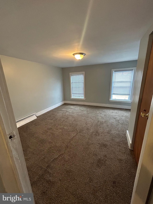 2229 Memphis St, Philadelphia, PA 19125 - empty room featuring a baseboard radiator, dark carpet, and baseboards