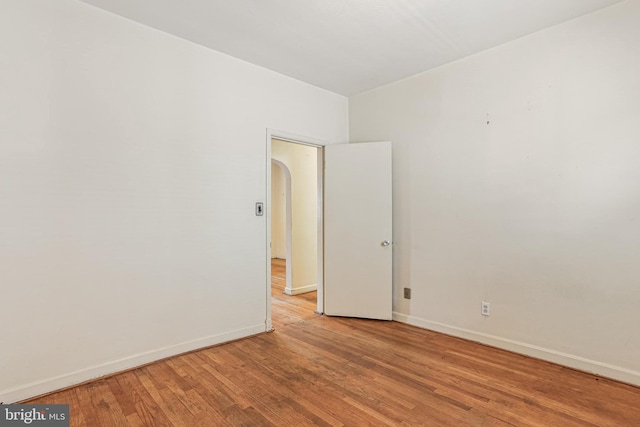 218 N Hammonds Ferry Rd, Linthicum Heights, MD 21090 - unfurnished room with light wood-type flooring, baseboards, and arched walkways