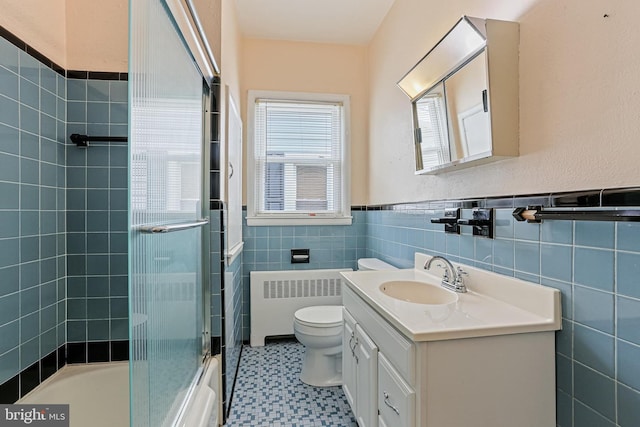 218 N Hammonds Ferry Rd, Linthicum Heights, MD 21090 - bathroom with radiator, toilet, vanity, tile walls, and tile patterned floors