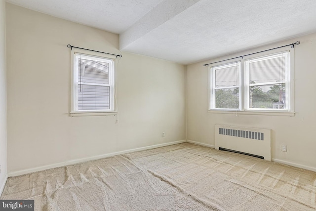 218 N Hammonds Ferry Rd, Linthicum Heights, MD 21090 - carpeted empty room with radiator, plenty of natural light, a textured ceiling, and baseboards