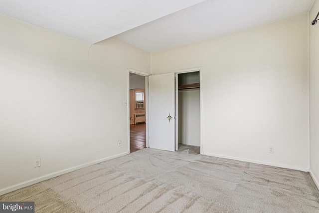 218 N Hammonds Ferry Rd, Linthicum Heights, MD 21090 - unfurnished bedroom with carpet flooring, baseboards, a closet, and radiator