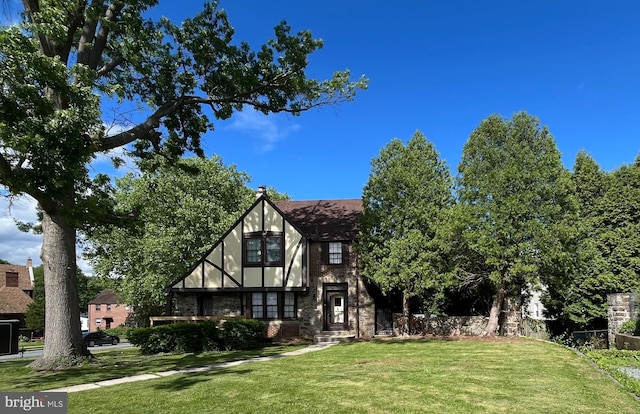 105 Hollywood Ave, Reading, PA 19606 - tudor-style house featuring a front lawn and stone siding