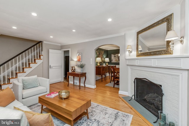 511 Wilton Rd, Towson, MD 21286 - living room featuring arched walkways, ornamental molding, recessed lighting, stairway, and light wood-style flooring