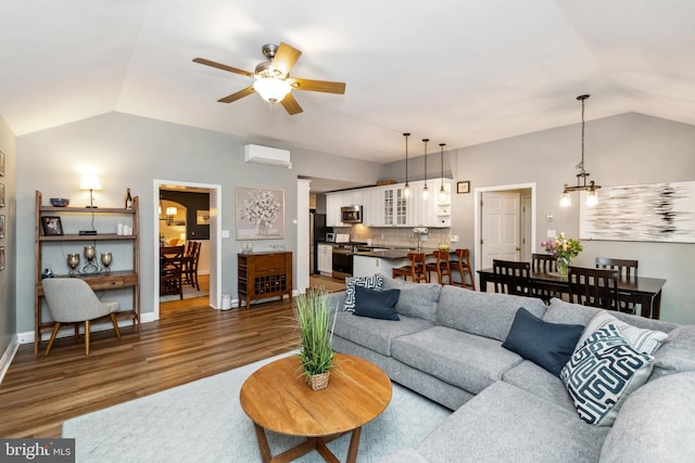 511 Wilton Rd, Towson, MD 21286 - living room featuring vaulted ceiling, a wall mounted AC, a chandelier, wood finished floors, and ceiling fan