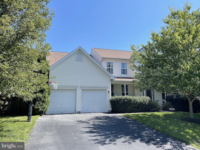 2974 Corona Ct, Manchester, MD 21102 - traditional-style home featuring driveway, a garage, a front lawn, and roof with shingles