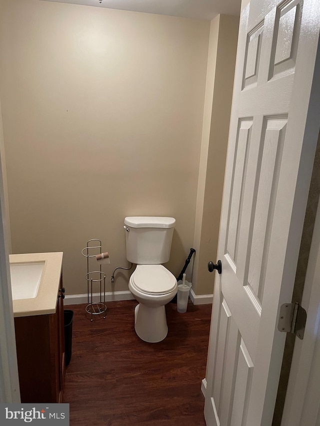2974 Corona Ct, Manchester, MD 21102 - half bath featuring vanity, toilet, wood finished floors, and baseboards