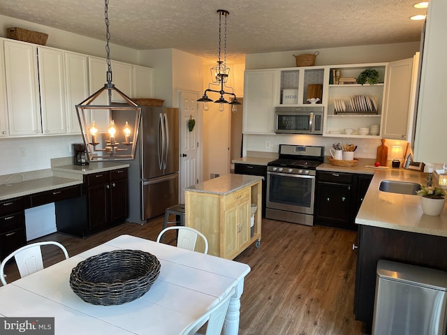 2974 Corona Ct, Manchester, MD 21102 - kitchen featuring appliances with stainless steel finishes, a chandelier, decorative backsplash, light countertops, and a textured ceiling