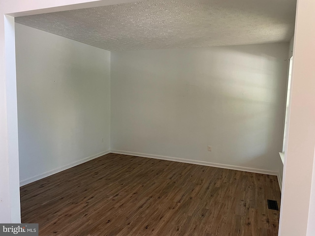 2974 Corona Ct, Manchester, MD 21102 - empty room featuring dark wood-type flooring, a textured ceiling, and baseboards