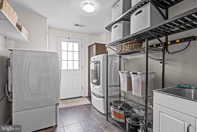1224 Mercer Dr, Haddonfield, NJ 08033 - laundry area featuring washer / dryer, cabinet space, and dark tile patterned floors