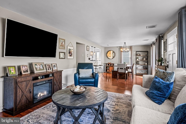1224 Mercer Dr, Haddonfield, NJ 08033 - living area featuring a chandelier, wood finished floors, and a glass covered fireplace