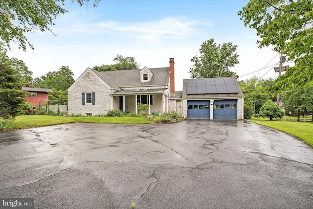 1010 Hampton Dr, Eastampton, NJ 08060 - view of front of property with a chimney, a front lawn, solar panels, and driveway