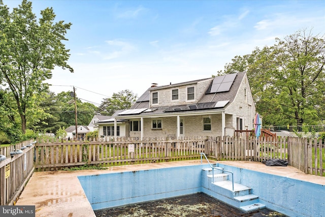 1010 Hampton Dr, Eastampton, NJ 08060 - rear view of property with solar panels, a chimney, and a deck