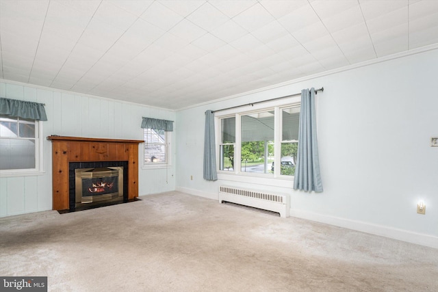 1010 Hampton Dr, Eastampton, NJ 08060 - unfurnished living room featuring radiator heating unit, carpet floors, a fireplace with flush hearth, ornamental molding, and baseboards