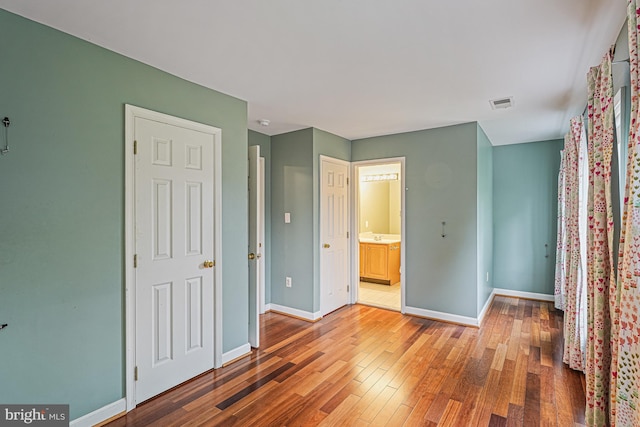 46825 Northbrook Way, Sterling, VA 20164 - unfurnished bedroom featuring wood finished floors, baseboards, and ensuite bath