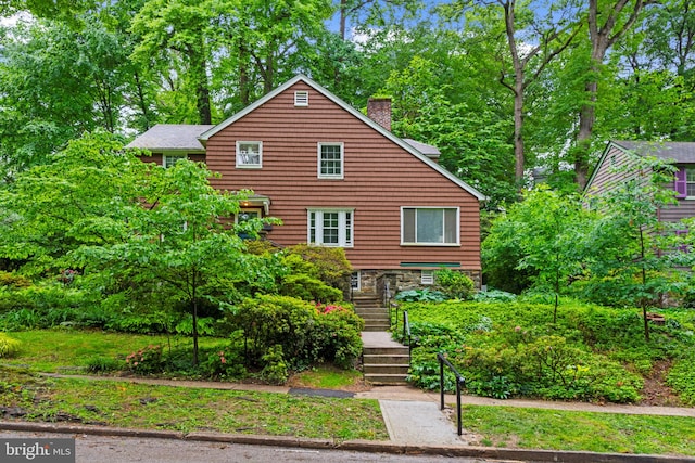 201 Deepdene Rd, Baltimore, MD 21210 - rustic home with a chimney, stairway, and view of wooded area