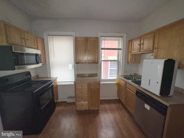 1515 N Franklin St, Wilmington, DE 19806 - kitchen with stainless steel appliances, dark wood-type flooring, a sink, light brown cabinets, and a wood stove
