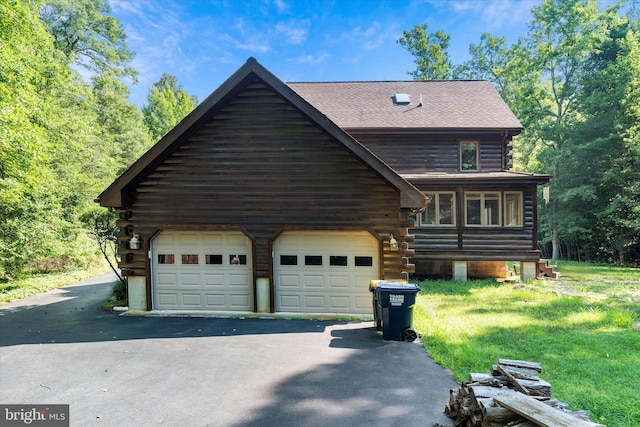 26 Wallamsey Ln, Chesapeake City, MD 21915 - log-style house featuring log exterior, driveway, a garage, a shingled roof, and a front yard