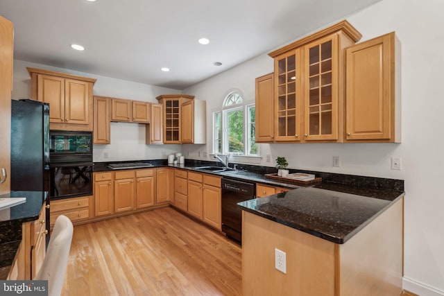 8109 Crooked Oaks Ct, Gainesville, VA 20155 - kitchen featuring black appliances, a sink, light wood-style floors, a peninsula, and glass insert cabinets