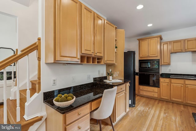 8109 Crooked Oaks Ct, Gainesville, VA 20155 - kitchen with black appliances, light wood-style floors, recessed lighting, light brown cabinetry, and dark stone counters