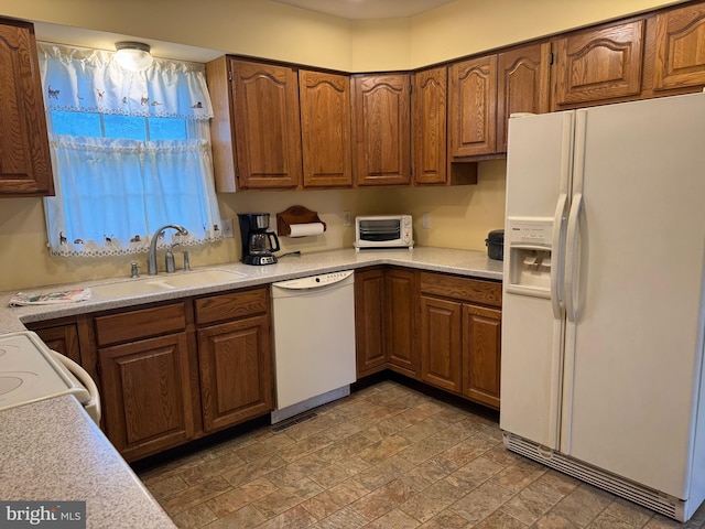 27836 Clearwater Ct, Salisbury, MD 21801 - kitchen with white appliances, light countertops, brown cabinetry, and stone finish flooring