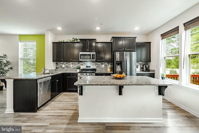 340 Dawson Pl, Downingtown, PA 19335 - kitchen with stainless steel appliances, light stone countertops, a center island, a breakfast bar, and a sink